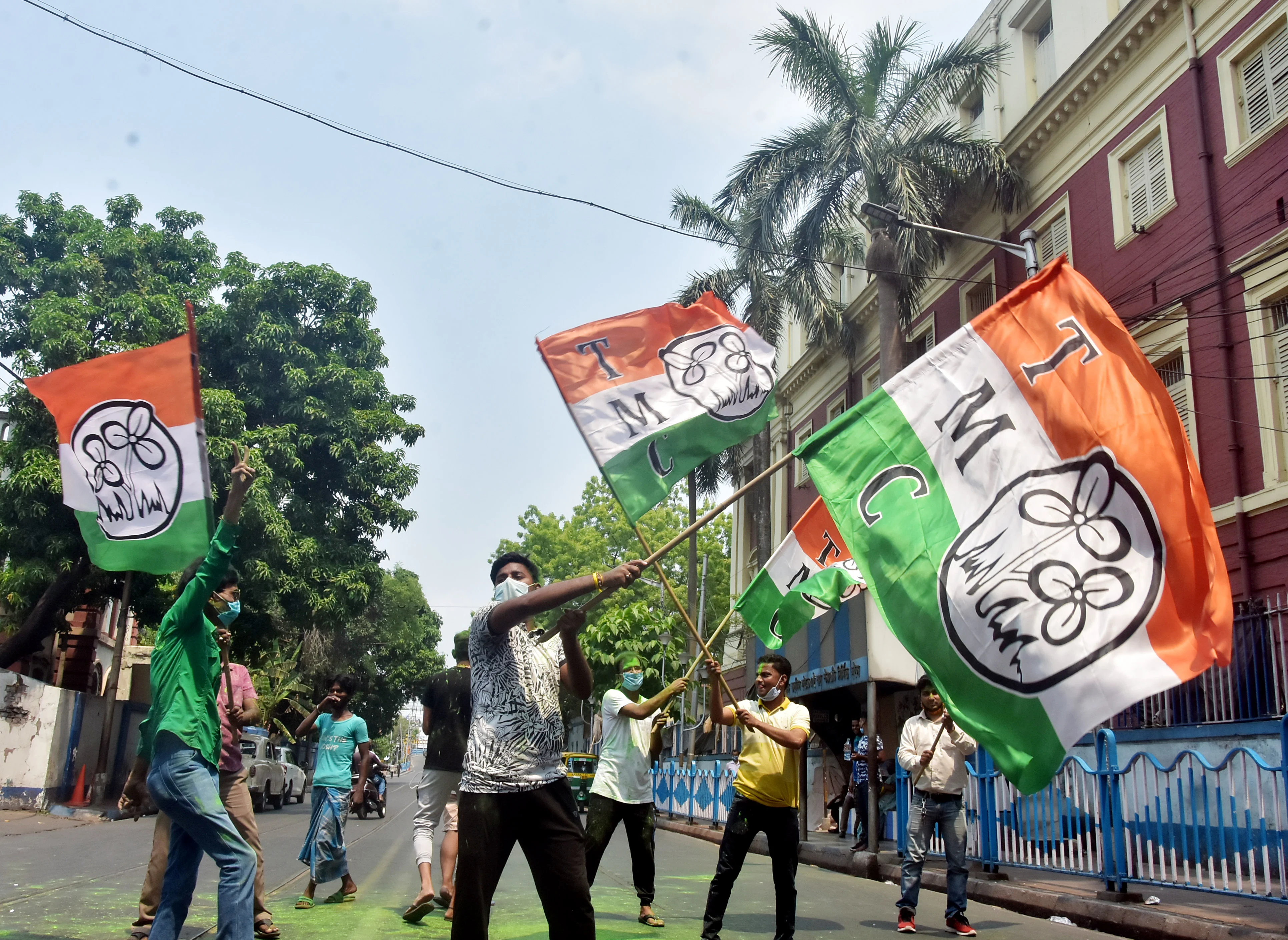 TMC supporters wave the party flag while celebrating the party's victory in West Bengal assembly election in front of West Bengal CM Mamata Banerjee's residence, in Kolkata on Sunday.