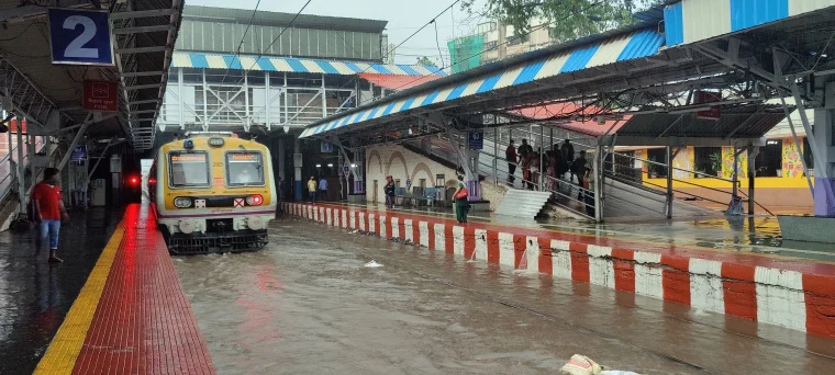 Local train arrives at waterlogged Sion station due to heavy rains
