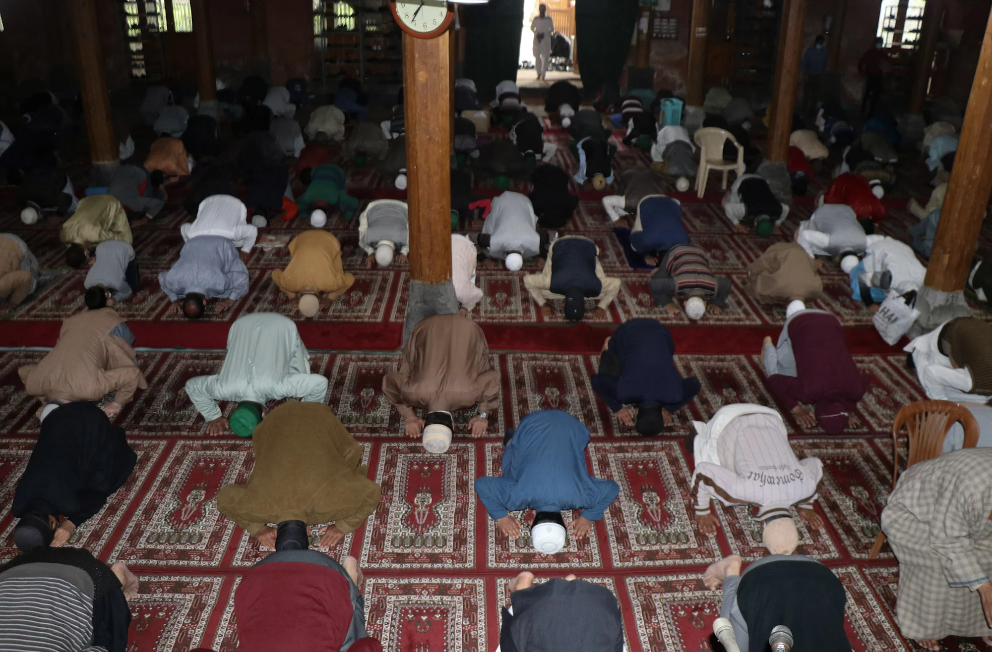 Kashmiri Muslims maintain social distance as they offer Eid prayers inside a mosque in Srinagar, Kashmir.
