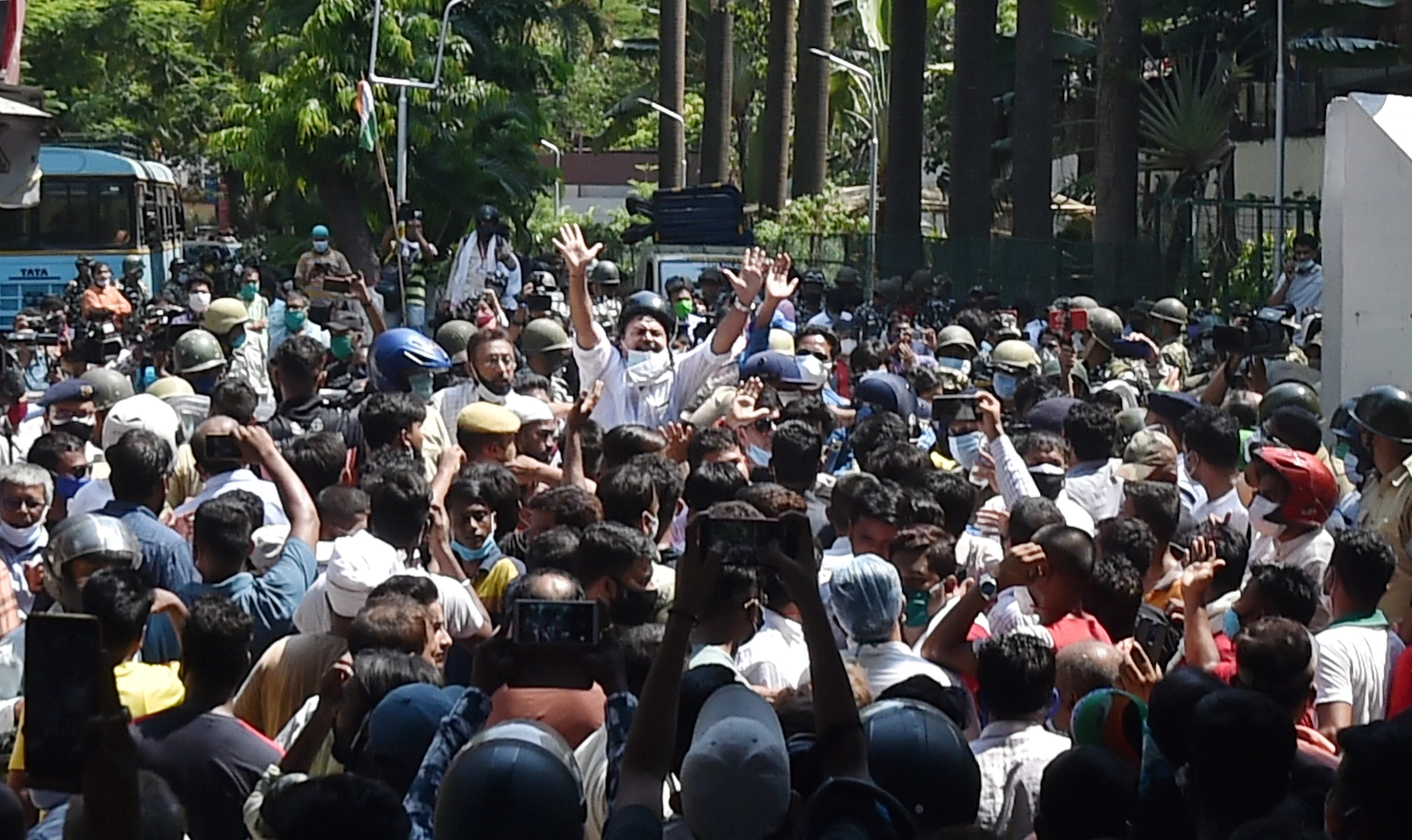 A local leader tries to control TMC workers gathered outside the CBI office Nizam Palace in protest over the arrest of party ministers and MLAs in connection with the Narada scam case, in Kolkata, Monday,