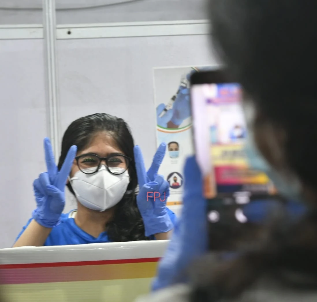 A beneficiary clicking selfie at a selfie booth on COVID-19 vaccination centre.