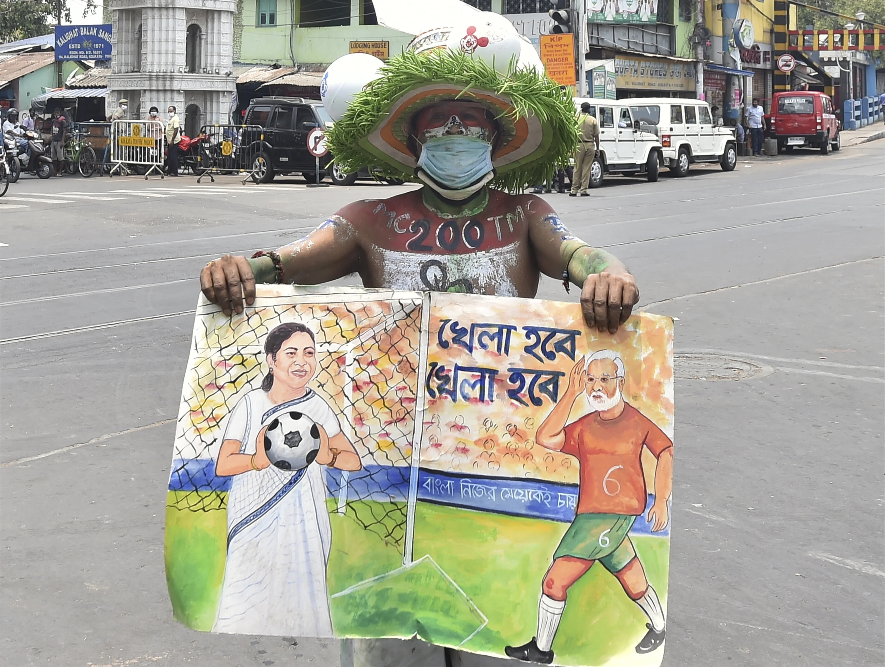 A TMC supporter holds a placard outside West Bengal Chief Minister Mamata Banerjee's residence at Kalighat during the counting of West Bengal Assembly poll, as the state government observes a shutdown to combat the Covid-19 situation, no gathering and rallies are strictly prohibited in this situation in Kolkata, Sunday, May 2, 2021.