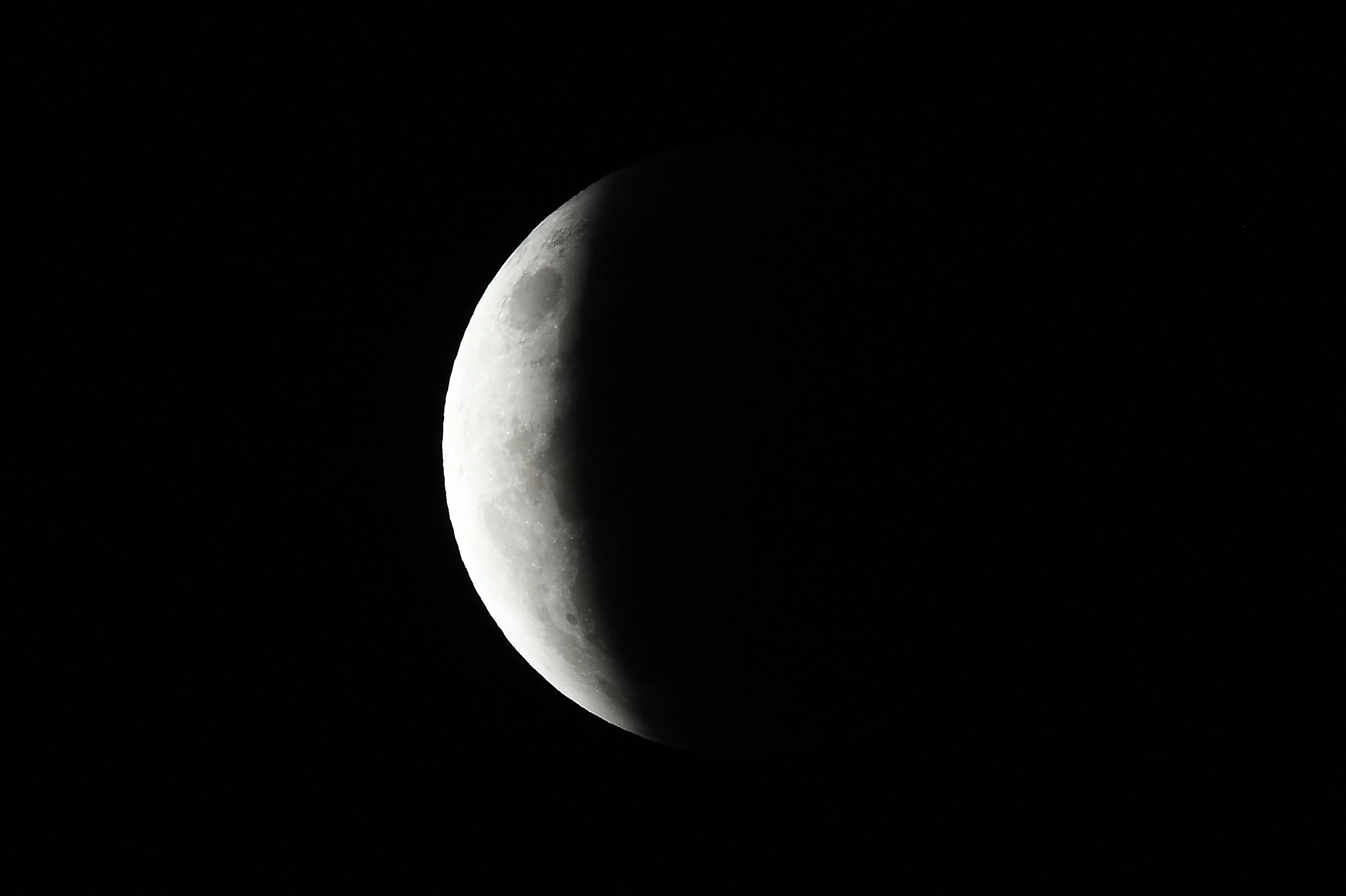 People set up their cameras and telecopes as they prepare to capture the "Super Blood Moon" in Singapore on May 26, 2021, ahead of a total lunar eclipse as stargazers across the Pacific cast their eyes skyward.