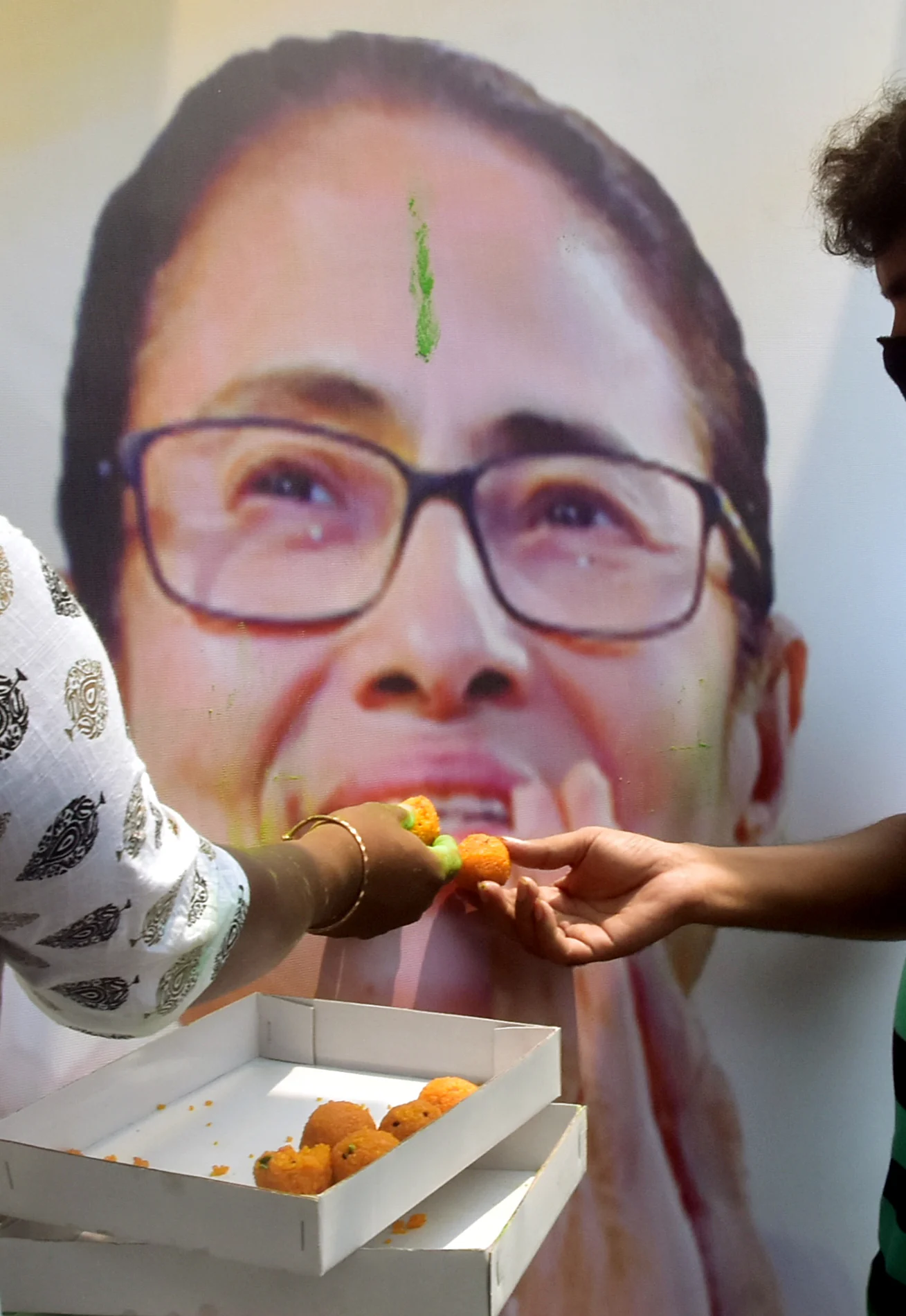 TMC supporters celebrate the partys victory in West Bengal assembly election in front of West Bengal CM Mamata Banerjees residence, in Kolkata on Sunday.