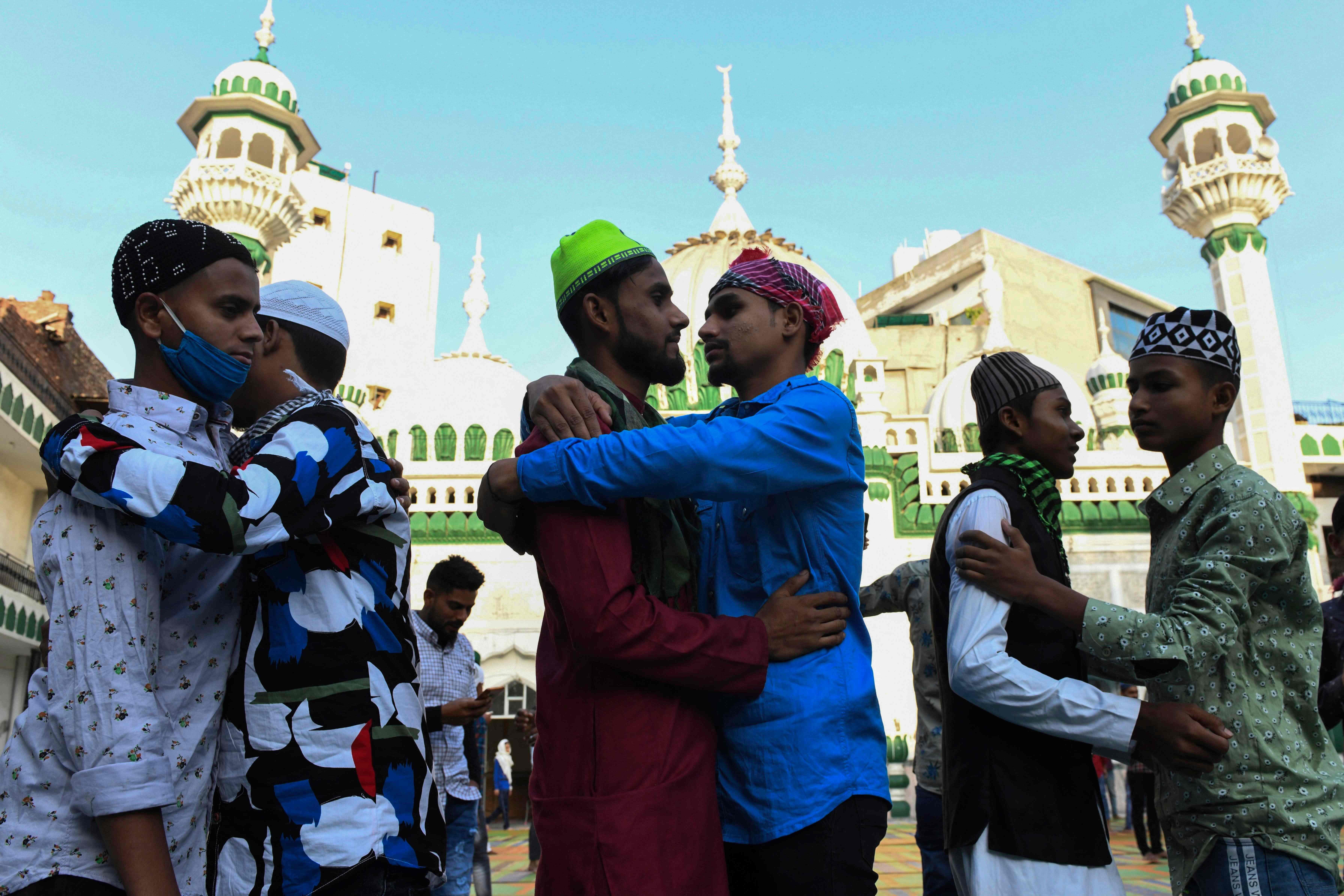 Muslim devotees hug each other after offering a special prayer on the occasion of Eid ul-Fitr festival, which marks the end of Islamic holy fasting month of Ramadan, at the Jama Masjid Khairuddin amid the coronavirus pandemic in Amritsar on May 14, 2021.
