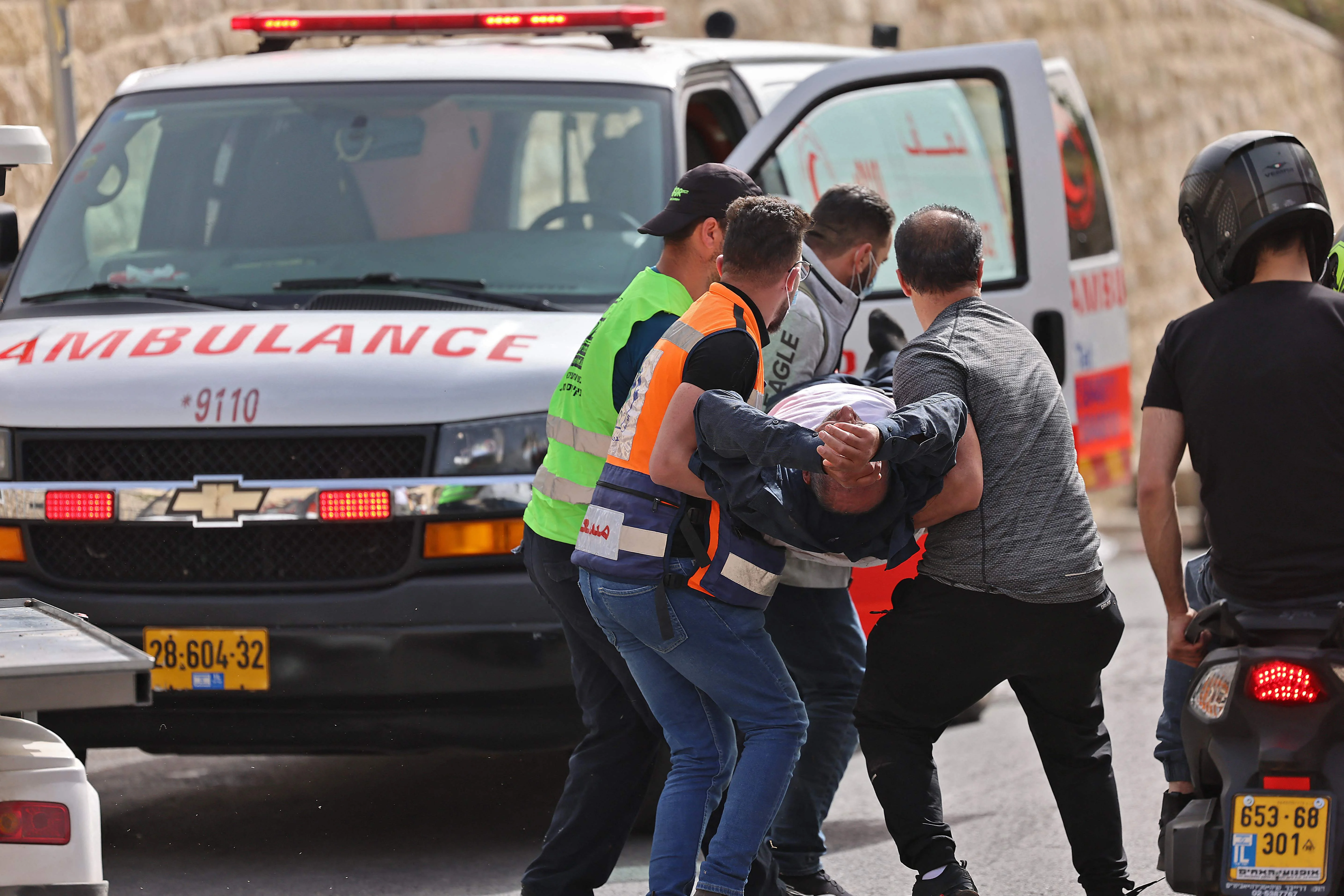 Palestinian medics evacuate a wounded protester amid clashes with Israeli security forces in Jerusalems Old City on May 10, 2021, ahead of a planned march to commemorate Israels takeover of Jerusalem in the 1967 Six-Day War.