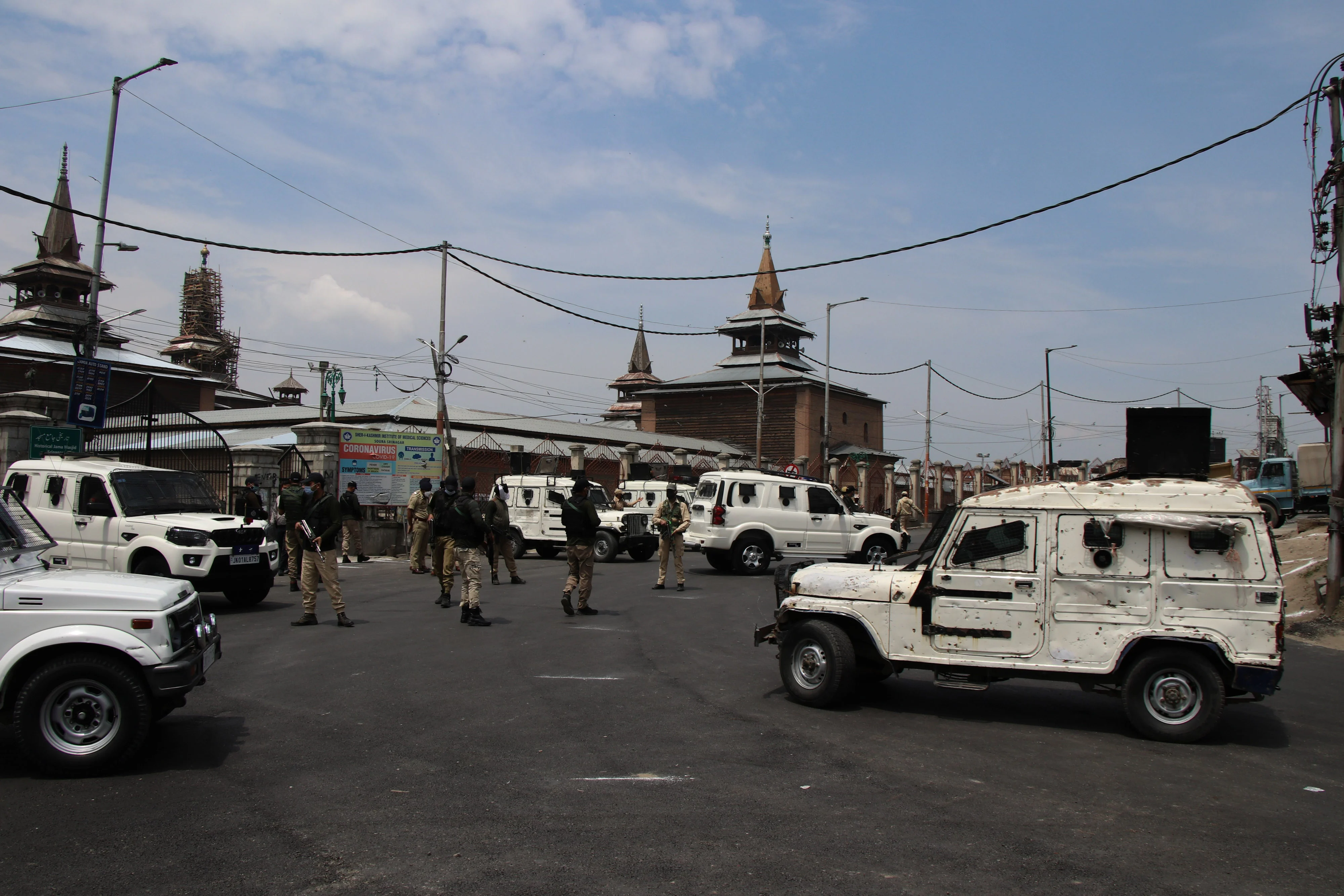 Security men stand guard on a deserted street during corona curfew in Srinagar, Kashmir. As the COVID-19 cases continue to rise the authorities imposed strict Corona curfew across Jammu and Kashmir in order to stop further spread of Coronavirus.