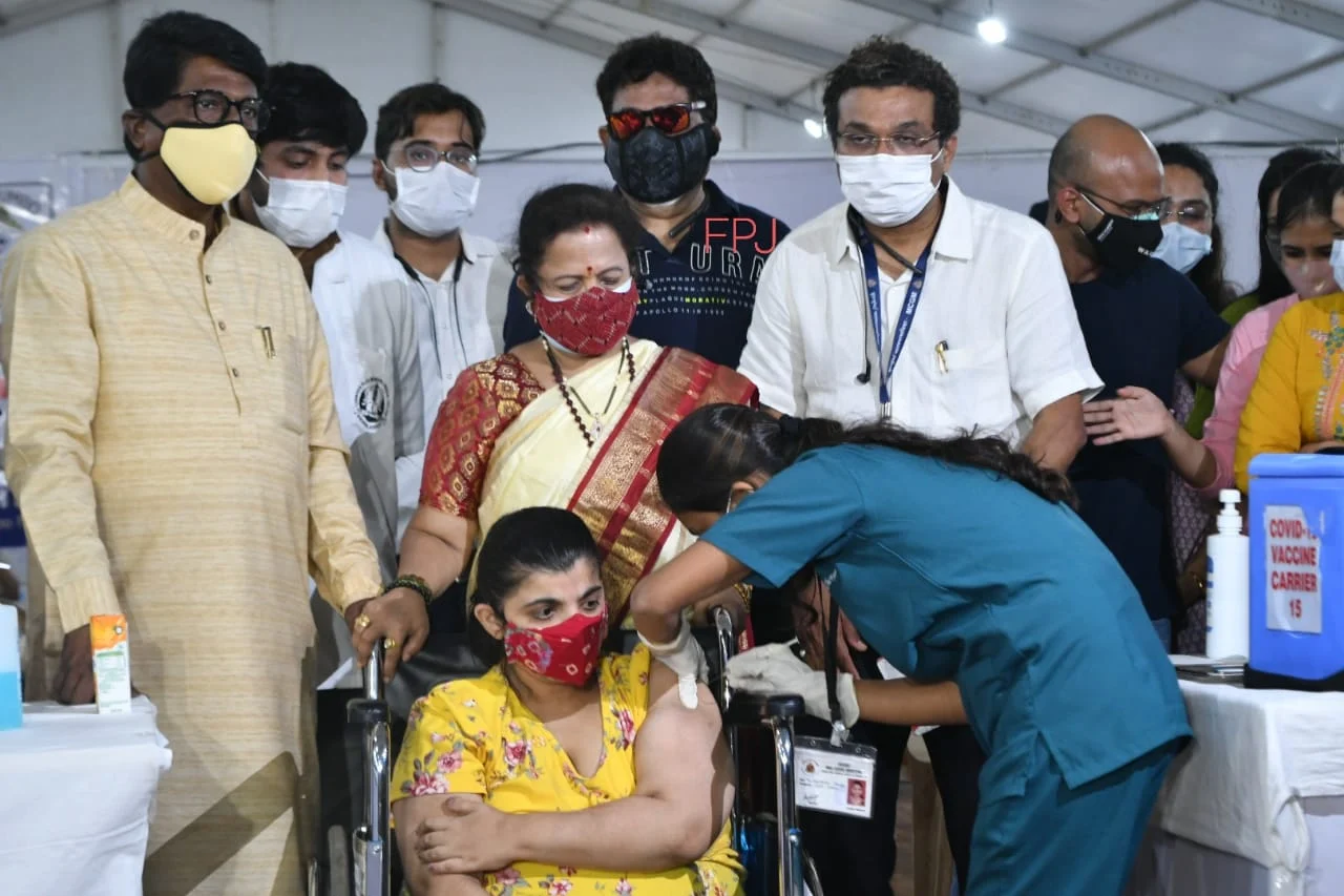 A beneficiary receives a dose of COVID-19 vaccine amid the rise in coronavirus cases.