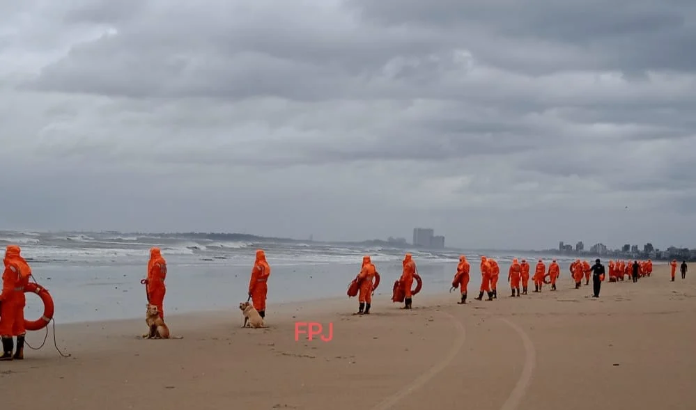 National Disaster Response Force (NDRF) officers stand guard at Juhu beach in Mumbai in view of Cyclone Tauktae in the Arabian sea on May 17, 2021.