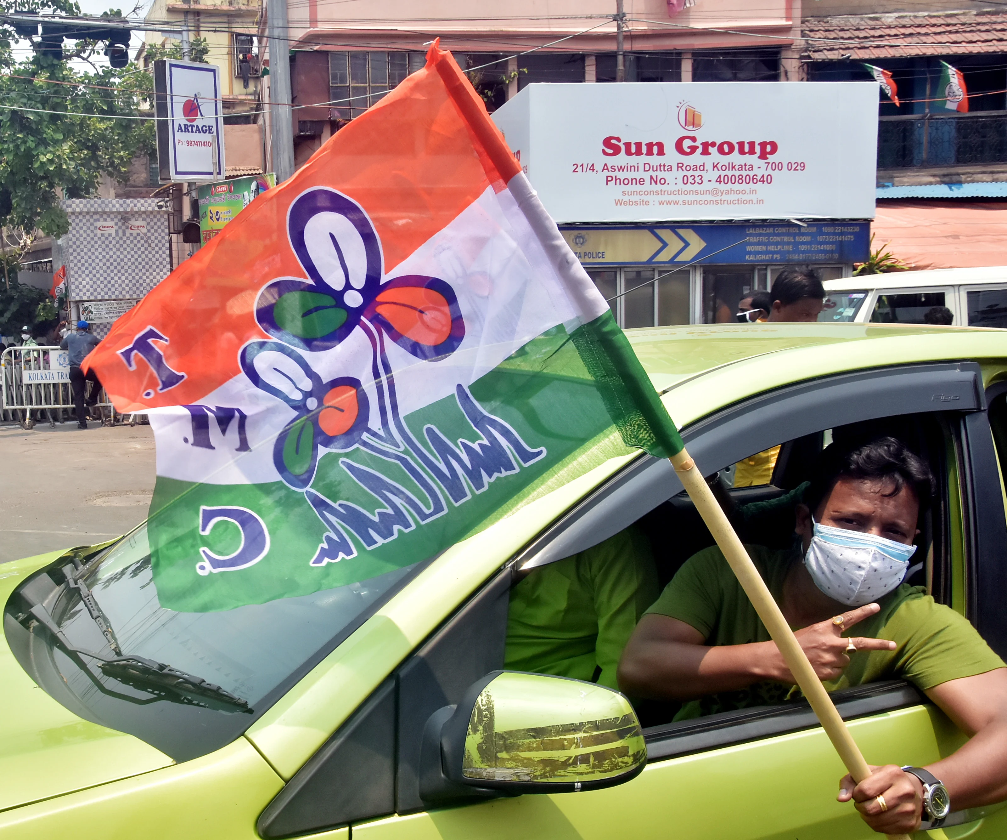 TMC supporter flashes a victory sign while celebrating the party's victory in West Bengal assembly election in front of West Bengal CM Mamata Banerjee's residence, in Kolkata on Sunday.