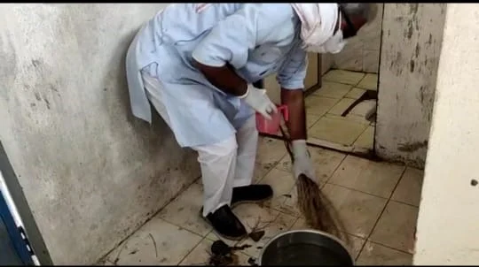 MP Janardan Mishra cleaning toilet at Kunj Bihari Covid care Centre in Rewa on Monday