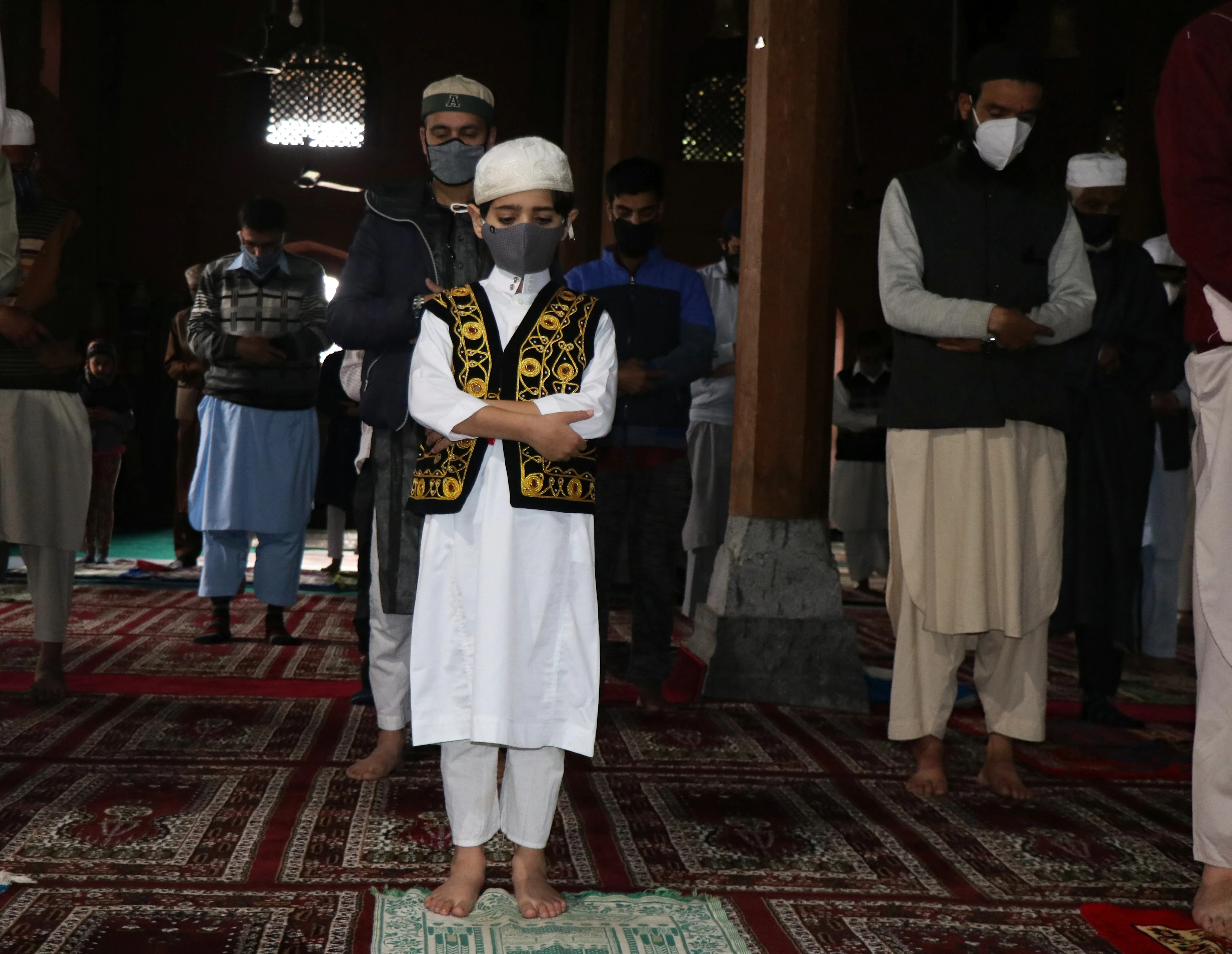 A Kashmiri child offers his prayers inside a local mosque on the occasion of Eid ul-Fitr in Srinagar, Kashmir.