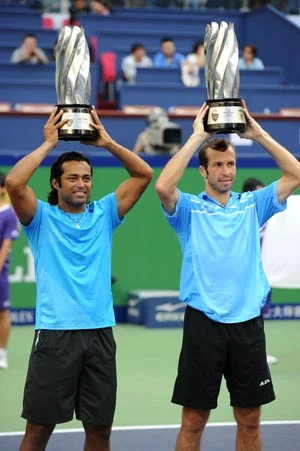 Leander Paes of India and Radek Stepanek of the Czech Republic hold their trophies after beating Mahesh Bhupathi and Rohan Bopanna of India in the doubles final of the Shanghai Masters tennis tournament in Shanghai on Sunday.