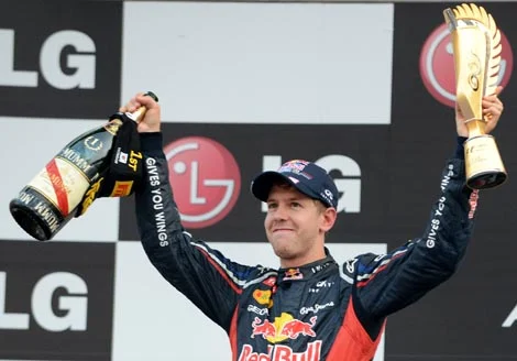 Sebastian Vettel lifts the Formula One Korean Grand Prix winner’s trophy and a bottle of champagne on the podium at the Korean Circuit in Yeongam on Sunday.