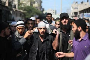 Palestinians carry the coffin of Salafist leader Hisham al-Saedini during his funeral procession at Al-Bureij refugee camp in the central Gaza Strip, on Sunday.