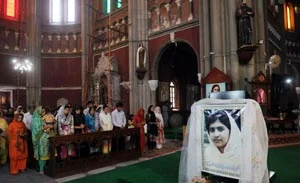 Pakistani Christians attend a mass prayer for the fast recovery of child activist Malala Yousafzai at a church in Lahore on Sunday.