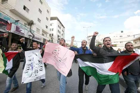 Hundreds of students from Hebron University some shouting and holding up the Palestinian flag demonstrate against the Israeli military attacks on the Palestinian Gaza strip, in the West Bank town of Hebron.