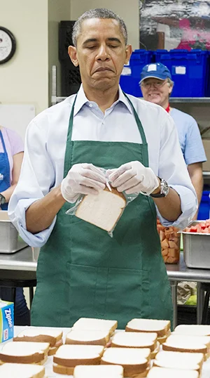 President Obama makes sandwiches at Martha’s Table. The organisation helps low income families and many volunteers are furloughed workers.