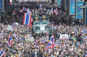 Anti-government protesters wave national flags during a demonstration in Bangkok earlier on Monday.