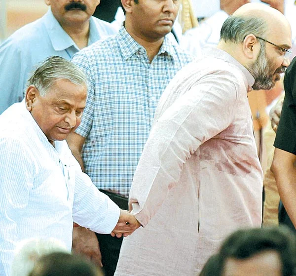 SIGN OF TIMES: BJP leader Amit Shah and SP chief Mulayam Singh Yadav giving each other a hand.