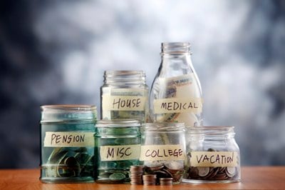Bottles of cash with coins isolated on the background.