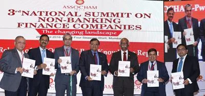 (L-R) RBI deputy governor, Mr R. Gandhi releasing summit backgrounder along with Assocham president, Mr Sunil Kanoria and other luminaries at an Assocham National Seminar on NBFCs: The Changing Landscape, in Mumbai