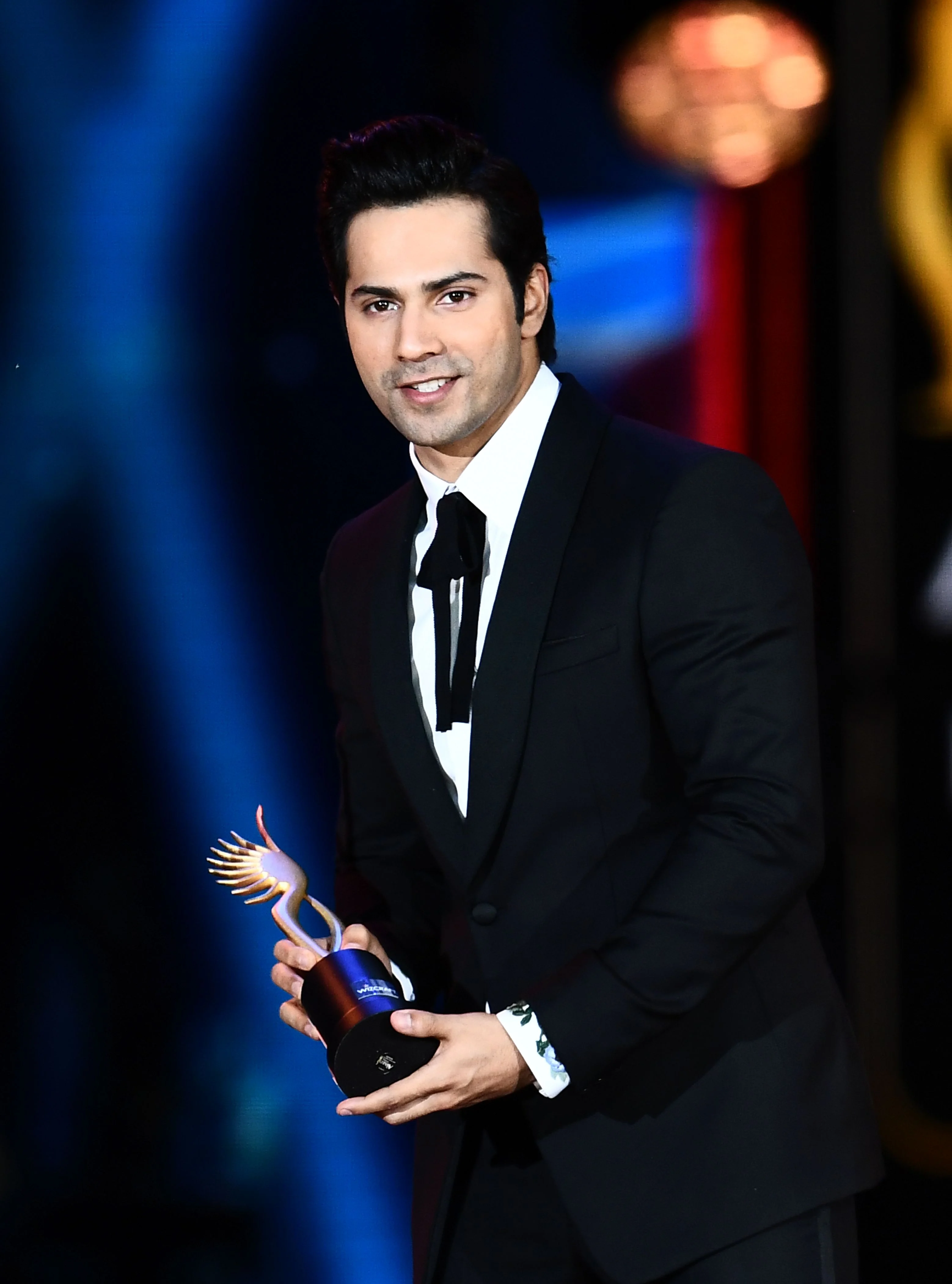 Winner of Performance in a Comic Role, Varun Dhawan (L) for “Dishoom” accepts the award during the 18th International Indian Film Academy (IIFA) Festival at the MetLife Stadium in East Rutherford, New Jersey, on July 15, 2017. / AFP PHOTO / JEWEL SAMAD