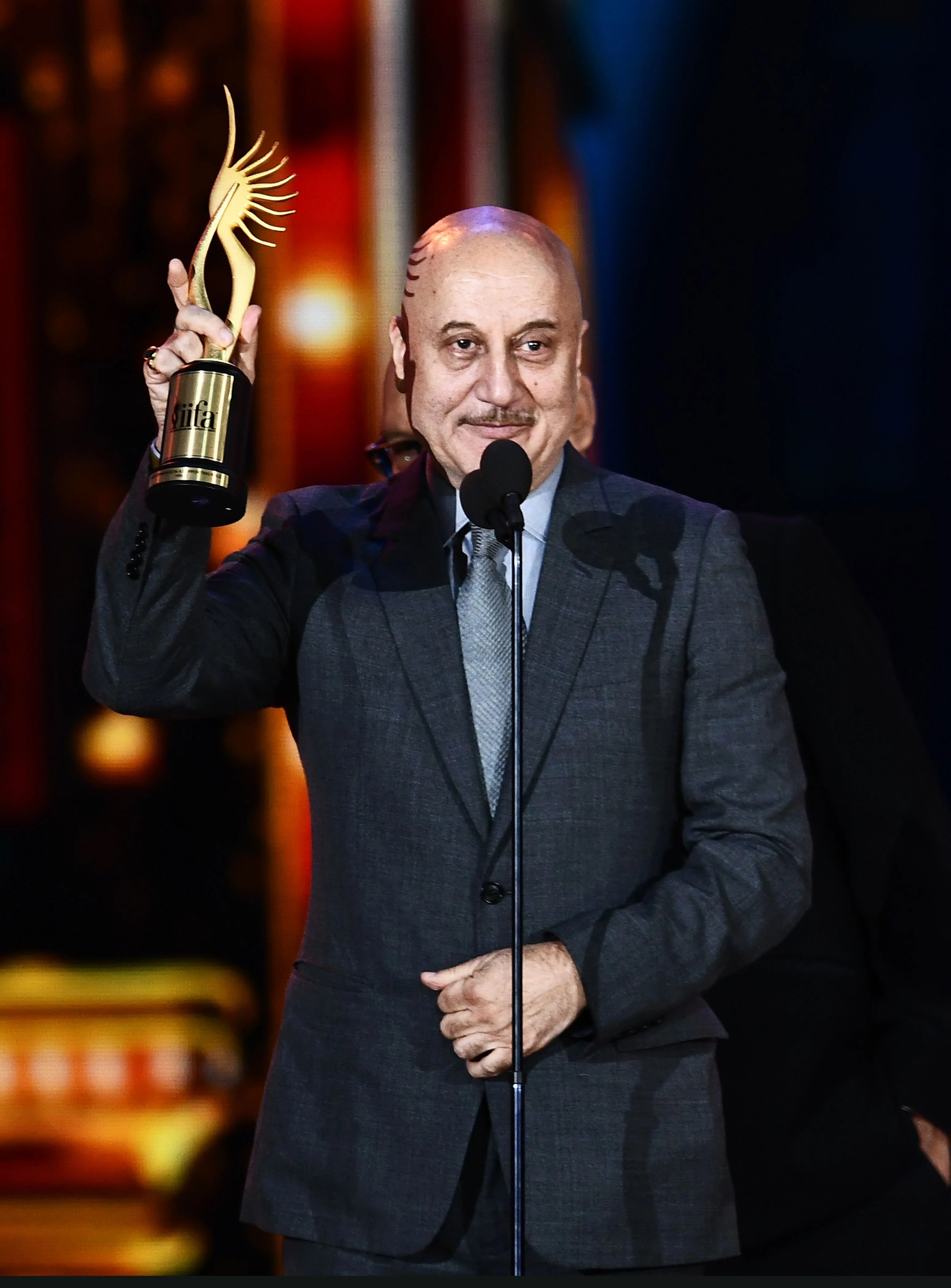 Winner of Performance in a Supporting Role – Male, Bollywood actor Anupam Kher for “M.S. Dhoni” accepts the award during 18th International Indian Film Academy (IIFA) Festival at the MetLife Stadium in East Rutherford, New Jersey, on July 15, 2017. / AFP PHOTO / JEWEL SAMAD