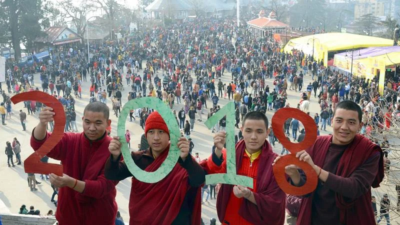 Monks hold cut-outs 0f 2018 to welcome the New Year at Ridge in Shimla on Sunday. PTI Photo