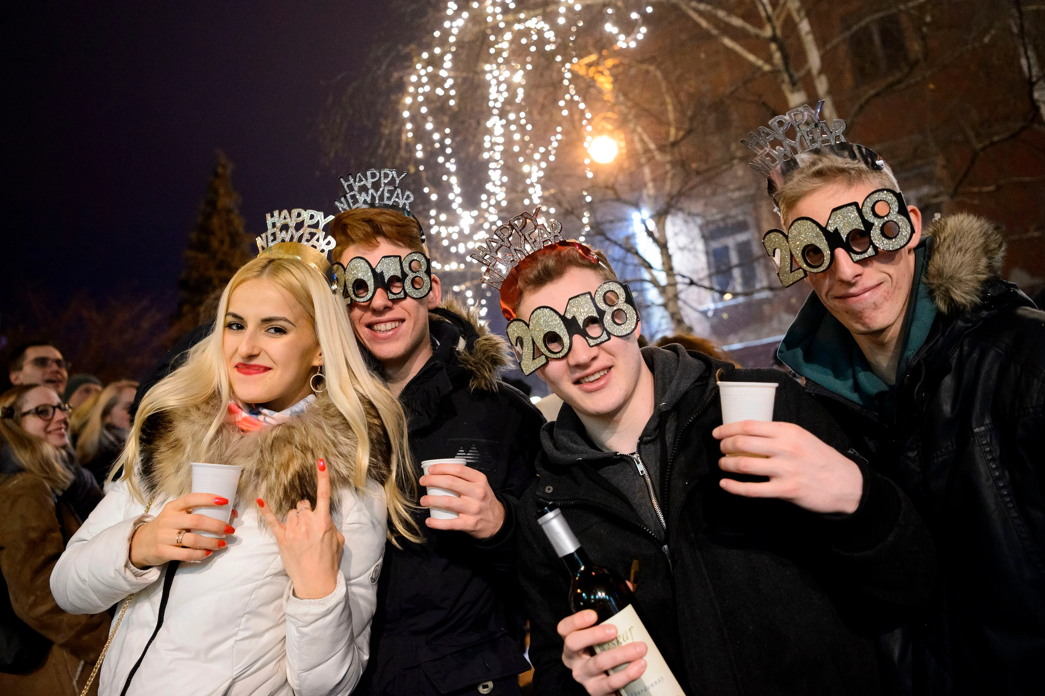 People celebrate during New Year’s celebrations just after midnight in Ljubljana, Slovenia on January 1, 2018. / AFP PHOTO / Jure Makovec