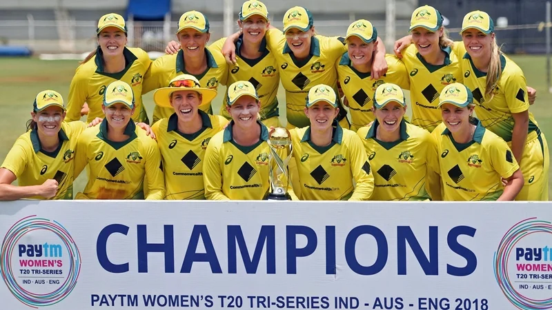 Australian players pose with the winning trophy after defeating England in the Tri-Nation Women’s T20I Series final match. PTI Photo by Shashank Parade
