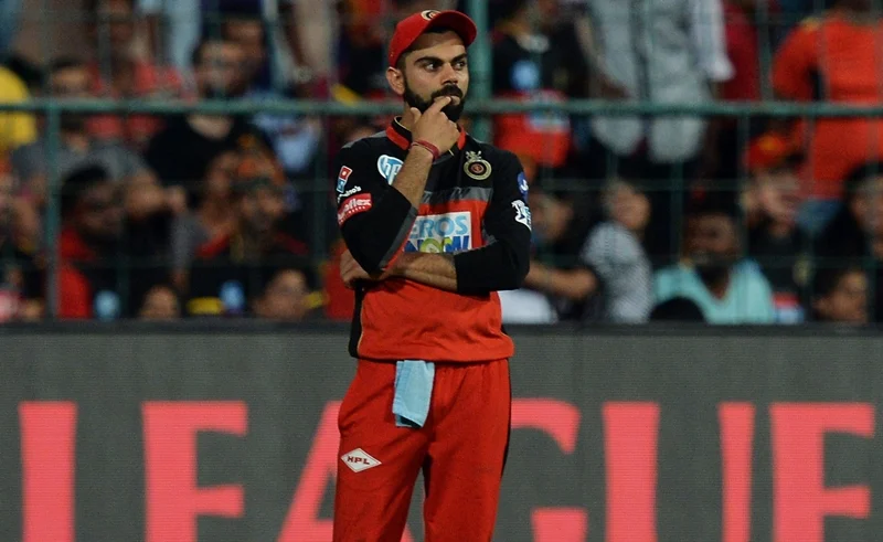 RCB captain Virat Kohli stands on the pitch during the match. / AFP PHOTO / Manjunath KIRAN / GETTYOUT
