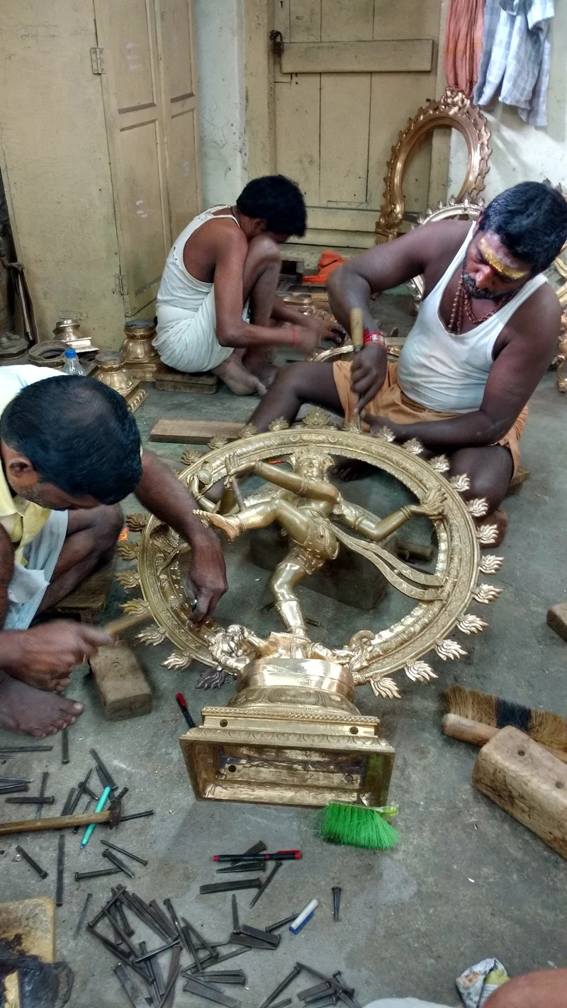 Workers sculpting a Bronze Nataraja at a workshop in Swamimalai