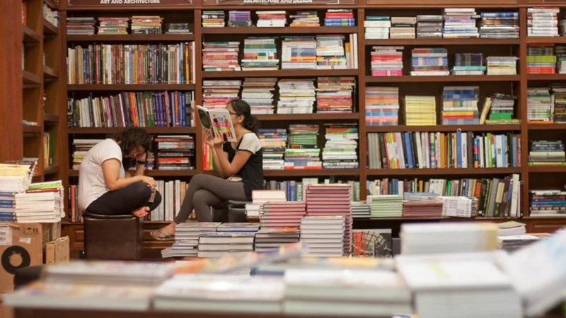 kitab khana: Readers are immersed in their respective books at Kitab Khana, Fort