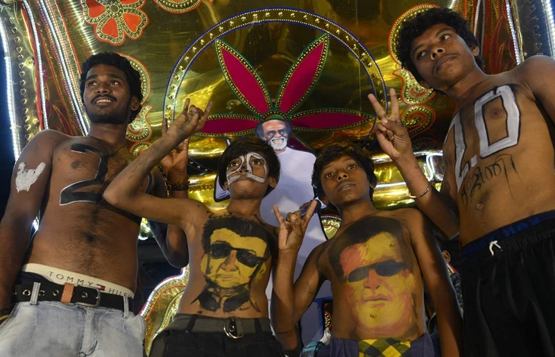 Indian fans of Bollywood star Rajinikanth display body paint with a portrait of the actor as they celebrate before attending the early morning show of his new Tamil-language film “2.0” on the first day of its release in Mumbai on November 29, 2018. (Photo by PUNIT PARANJPE / AFP)