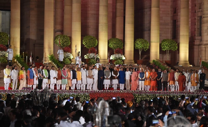 Newly sworn-in Indian Prime Minister Narendra Modi (center R) and cabinet ministers stand with President of India Ram Nath Kovind (center L) after taking the oath of office at the President house in New Delhi on May 30, 2019. - India's Prime Minister Narendra Modi was sworn in Thursday in front of cheering supporters ahead of unveiling a drastically revamped Hindu nationalist government for his historic second term. Modi was the first of more than 50 cabinet ministers and deputy ministers to take the oath of office at the presidential palace in front of 8,000 people including South Asian leaders, Bollywood stars and leading political figures. (Photo by PRAKASH SINGH / AFP)