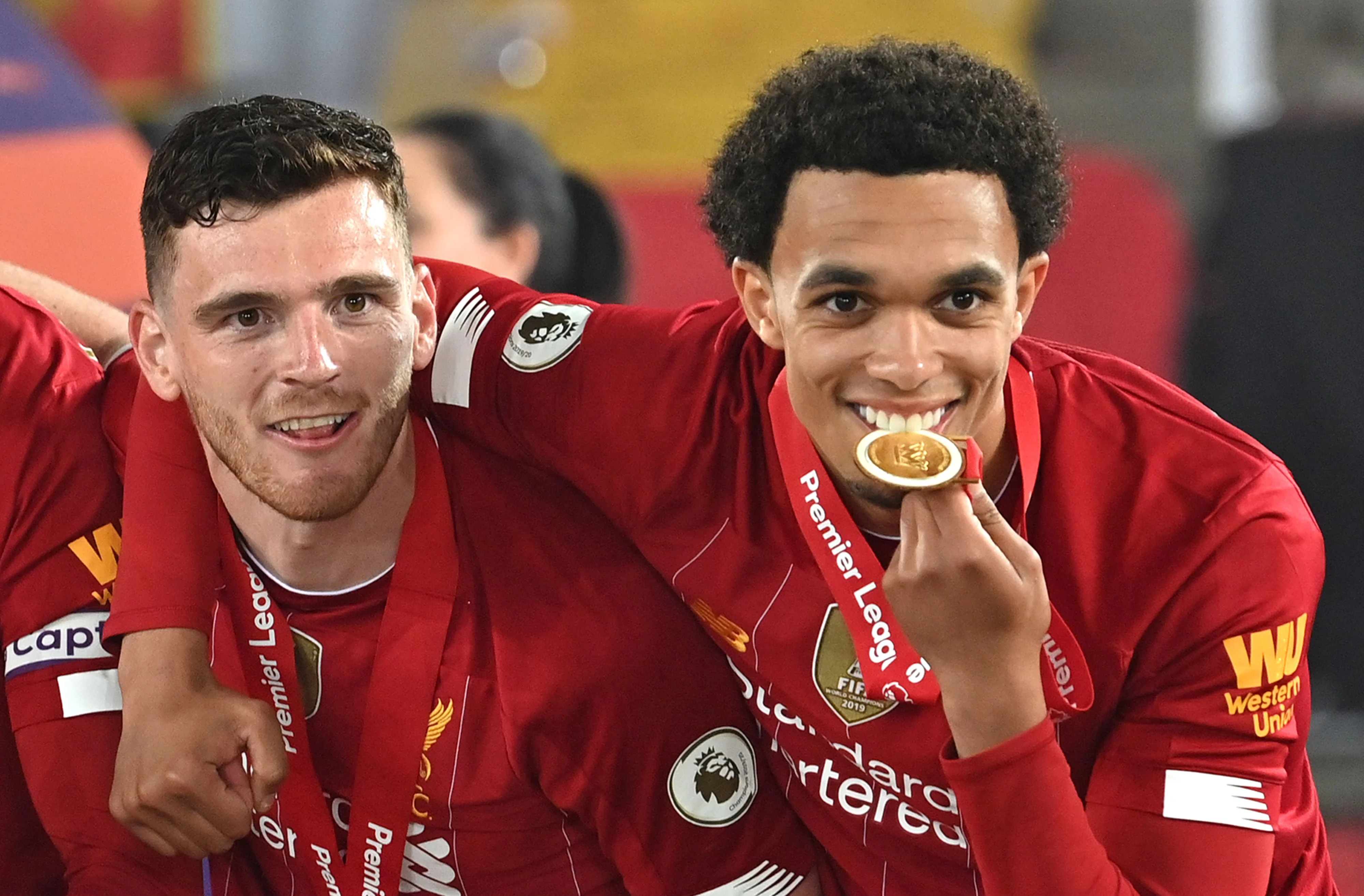 (L-R) Liverpools Scottish defender Andrew Robertson and Liverpools English defender Trent Alexander-Arnold pose during the Premier League trophy presentation following the English Premier League football match between Liverpool and Chelsea at Anfield in Liverpool, north west England