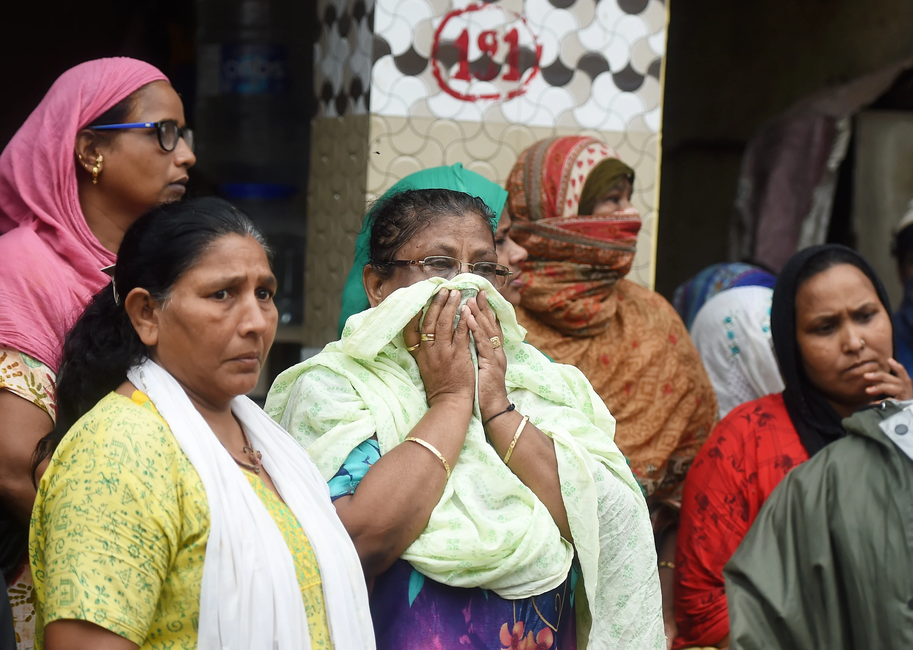 Relatives and friends react on the death of a person, after a single-storey house collapsed on another structure in Malwani area on Wednesday night, in Mumbai, Thursday, June 10, 2021. At least eight children and three adults were killed and seven other people injured in the mishap.