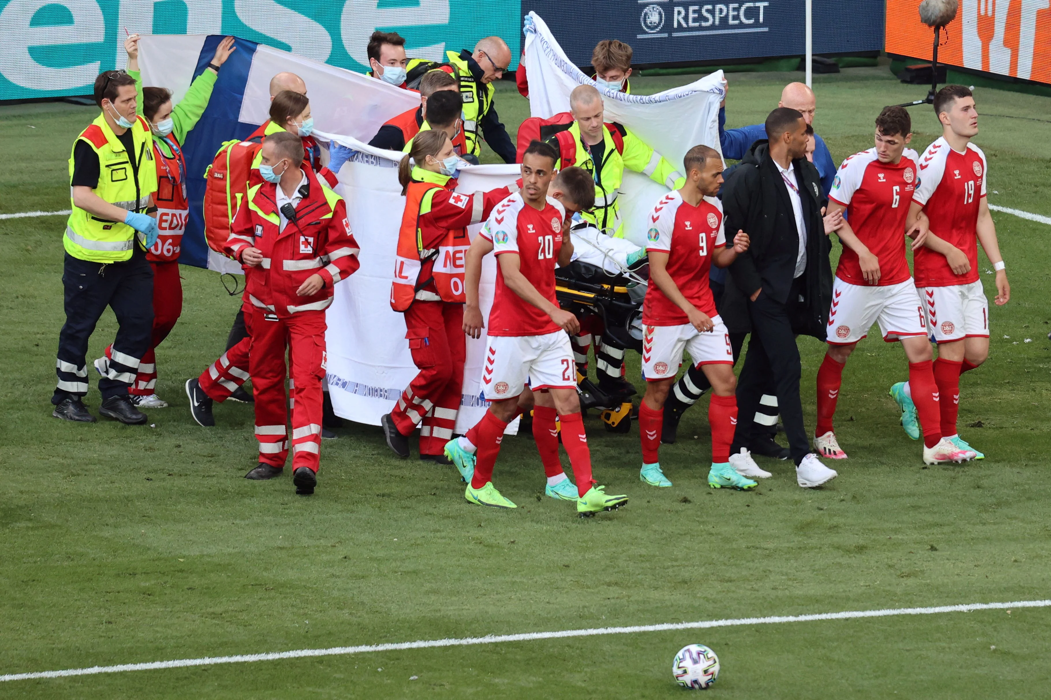 Denmark players gather as paramedics attend to midfielder Christian Eriksen after he suffered a cardiac arrest in the opening Uefa Euro 2020 match against Finland