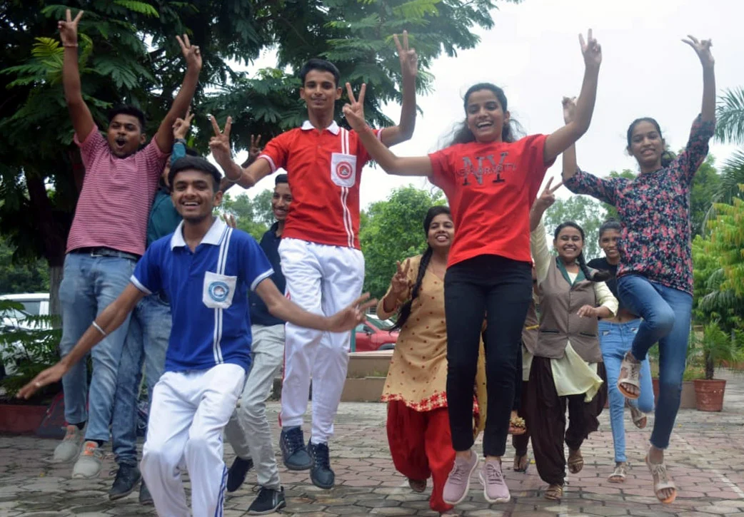 Students celebrating after declaration of result of class 12 in Bhopal on Thursday