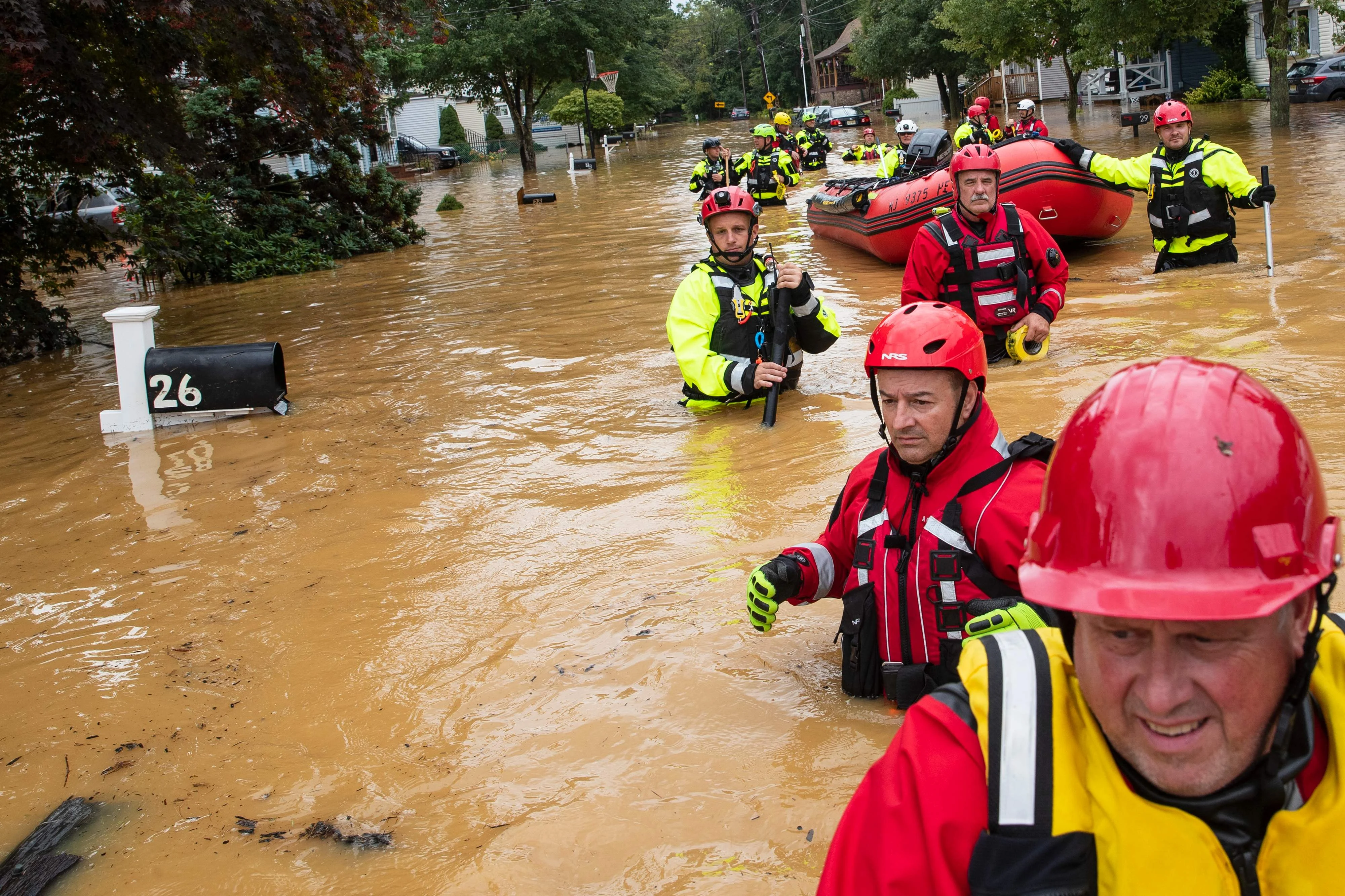 Rescue workers search during an evacuation effort following a flash flood, as Tropical Storm Henri makes landfall, in Helmetta, New Jersey.