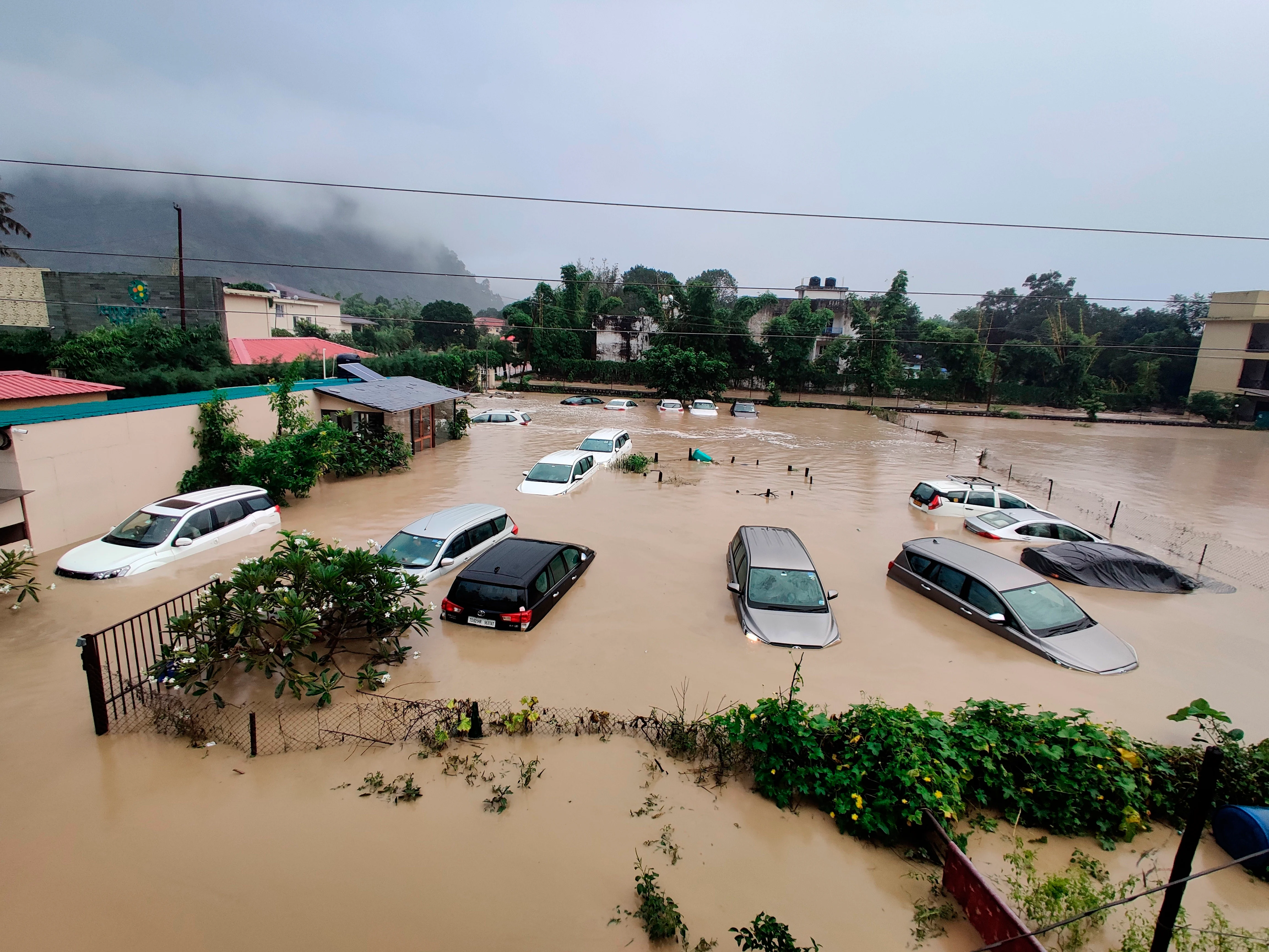 Uttarakhand: Submerged cars are seen at a flooded hotel resort as extreme rainfall caused the Kosi River overflow at the Jim Corbett National Park in Uttarakhand, India, Tuesday, Oct.19, 2021.