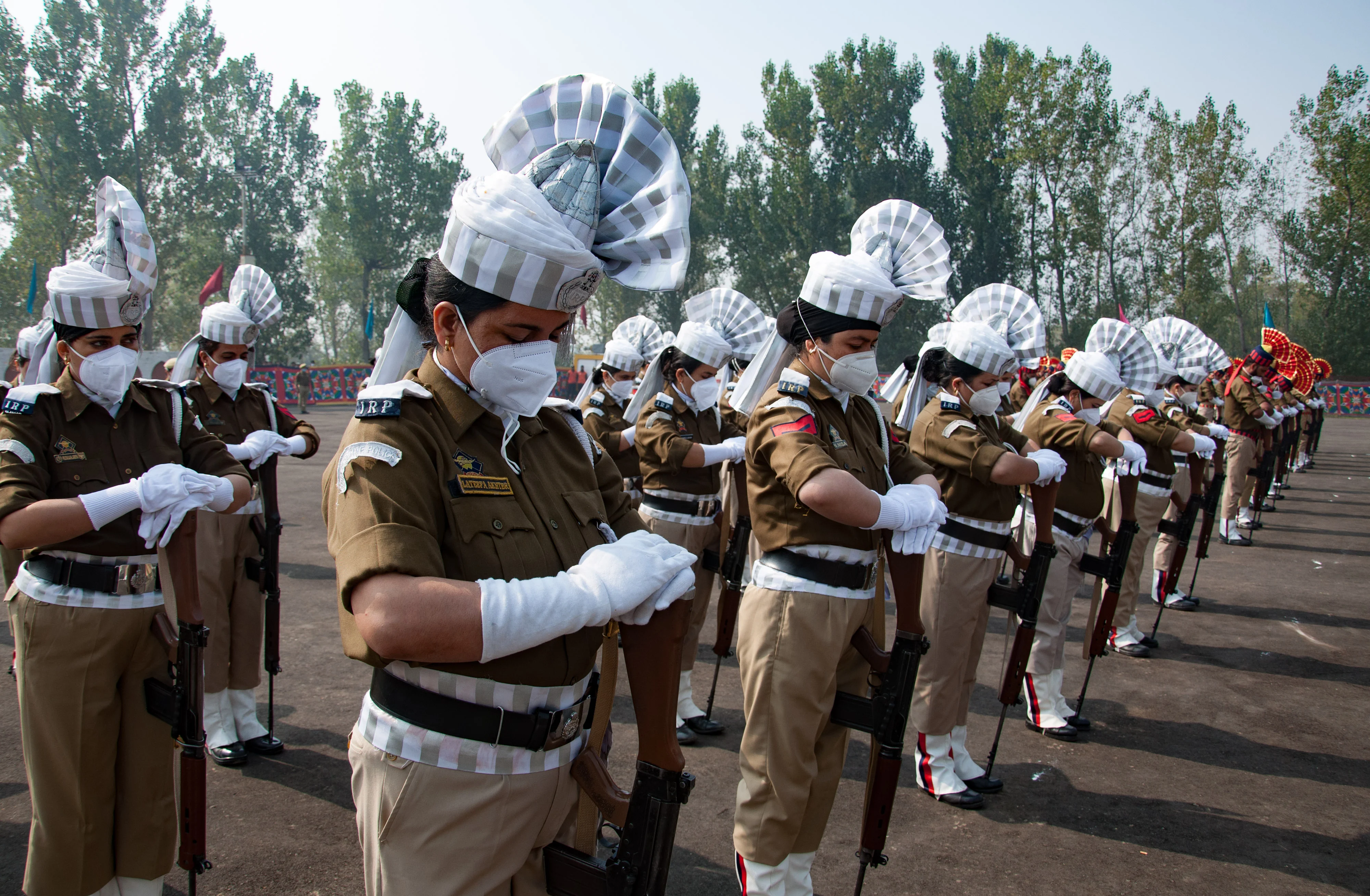 Policewomen bow their head in honor of the slain colleagues during a ceremony to mark the National Police Commemoration Day at the Police Training Centre in Zewan on the outskirts of Srinagar, on Thursday 21 October 2021.