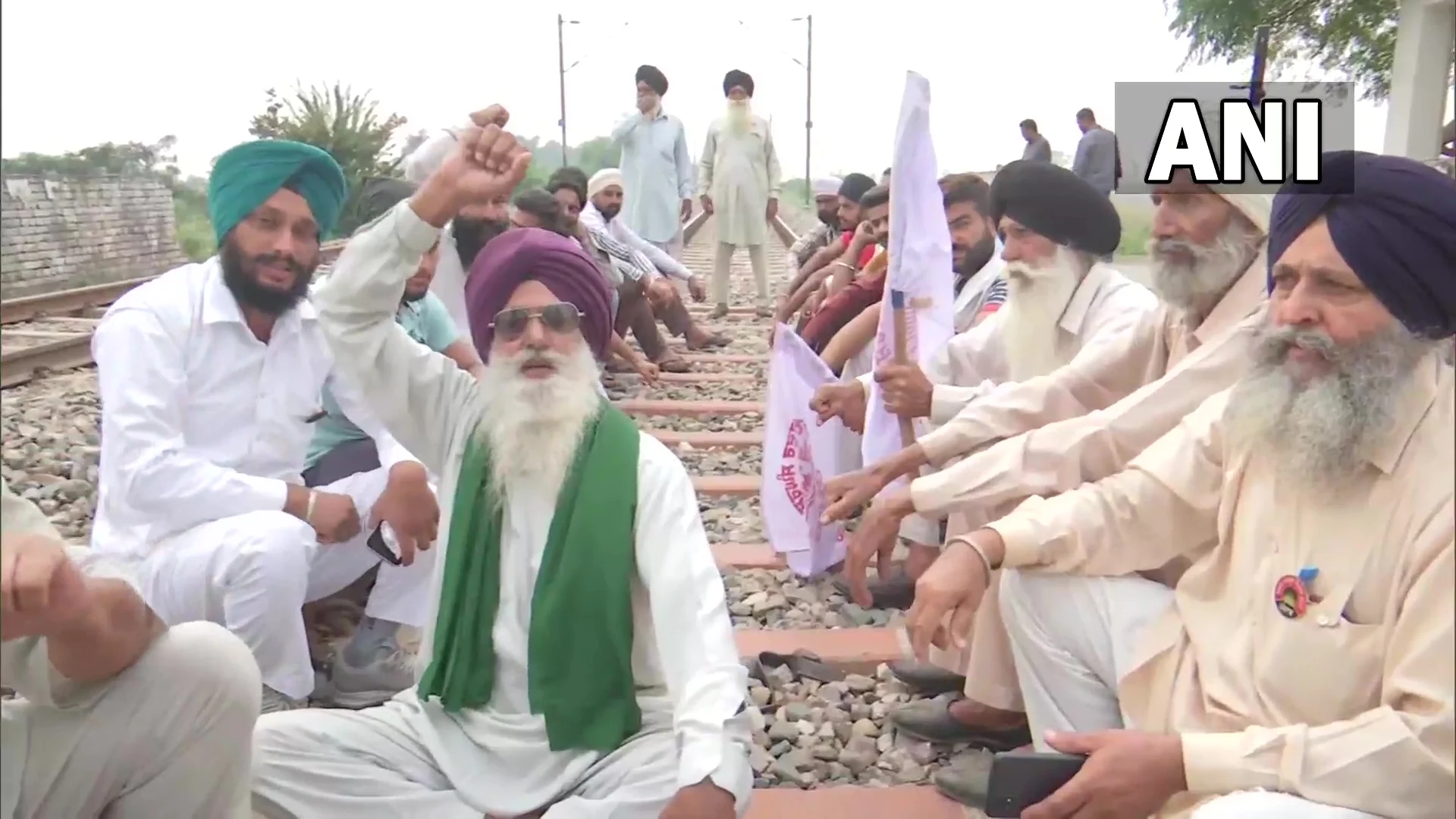Farm law protestors sit on the railway track at Devi Dasspura village in Amritsar, Punjab, following the farmer's union call for 'Rail Roko Andolan' on Monday, October 18, 2021.