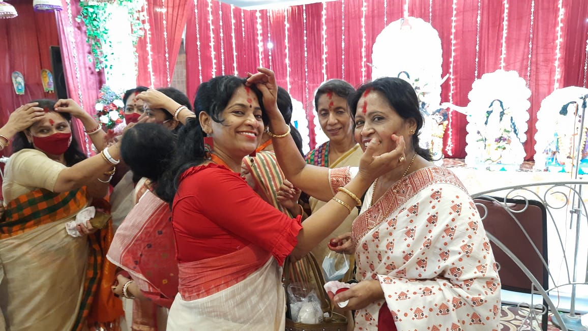 Women participate in Sindoor Khela at a puja pandal on the last day of Durga Puja celebrations in Mumbai, Friday, Oct. 15, 2021.