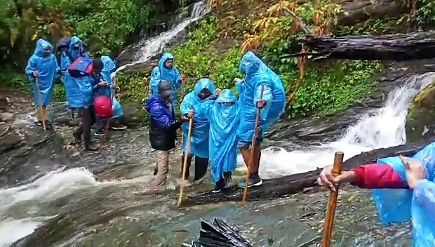 The forest department rescues 10 passengers who were stranded at Kalchanth on the Rudranath trek route due to heavy rains, in Chamoli on Tuesday. (A