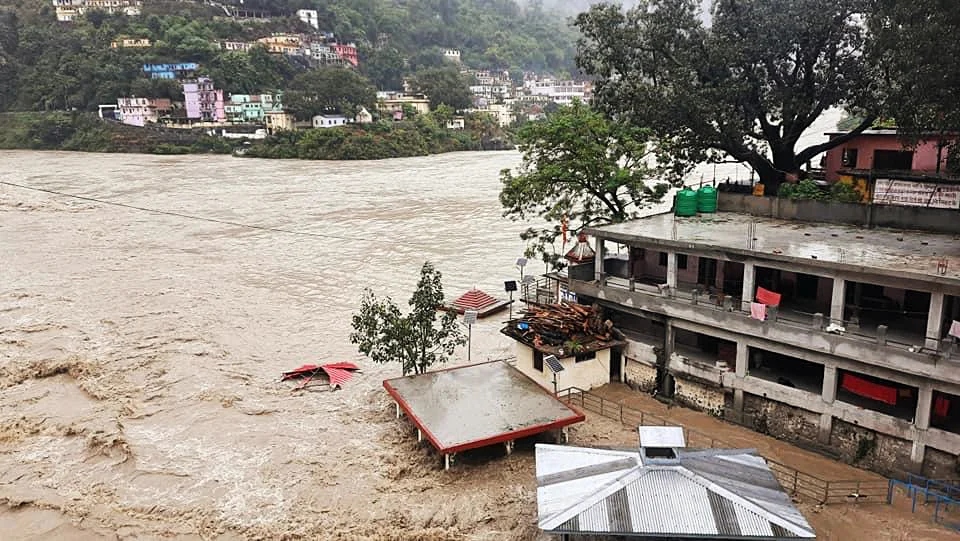Bathing ghats submerged underwater at the confluence of Alakananda River and Pindar river due to heavy rainfall, in Chamoli on Tuesday. (ANI Photo)