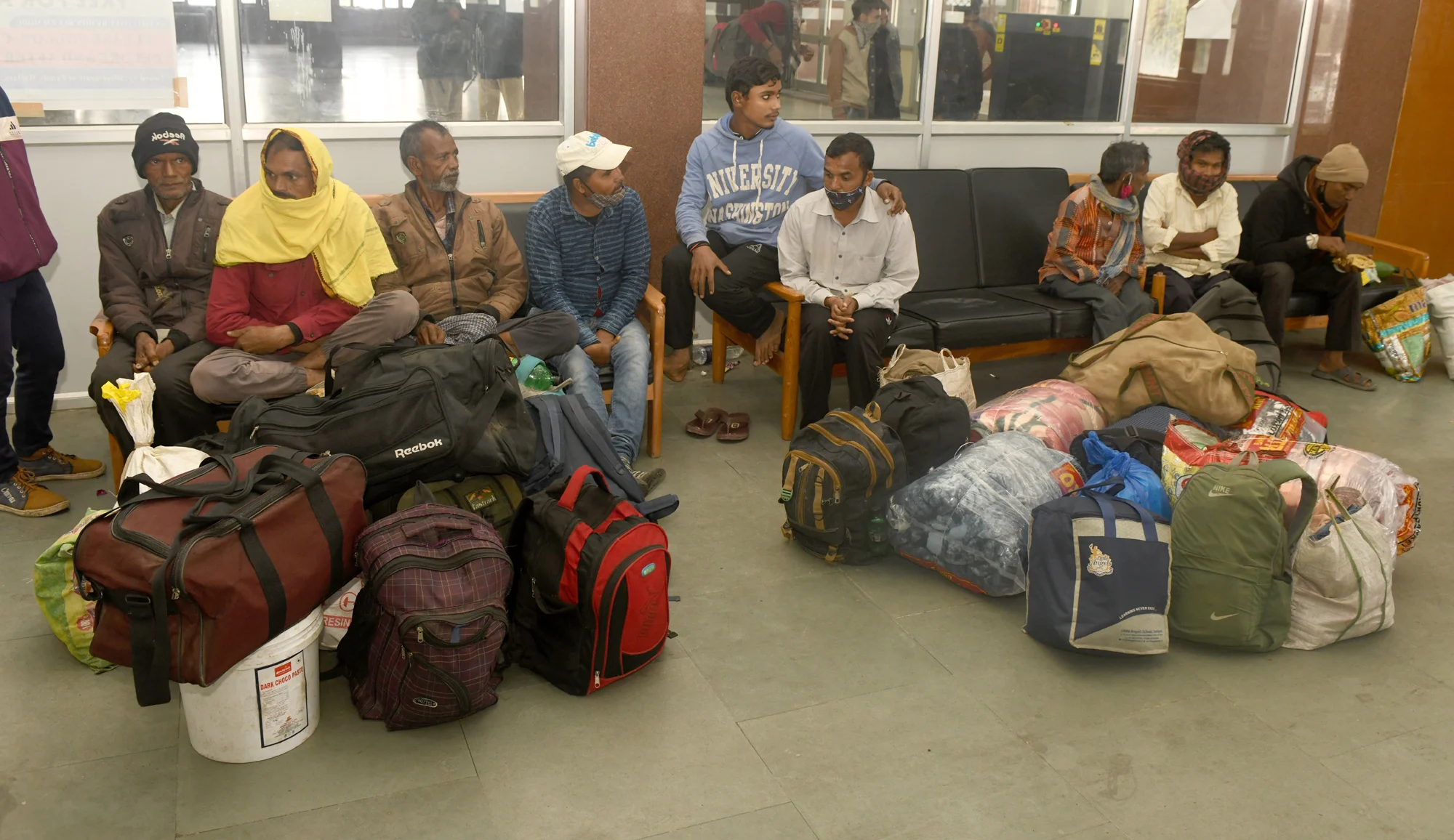 Group of Migrant workers wait at a railway station in Srinagar to return to their home after fresh of violence against civillians including non locals in the past week across Kashmir