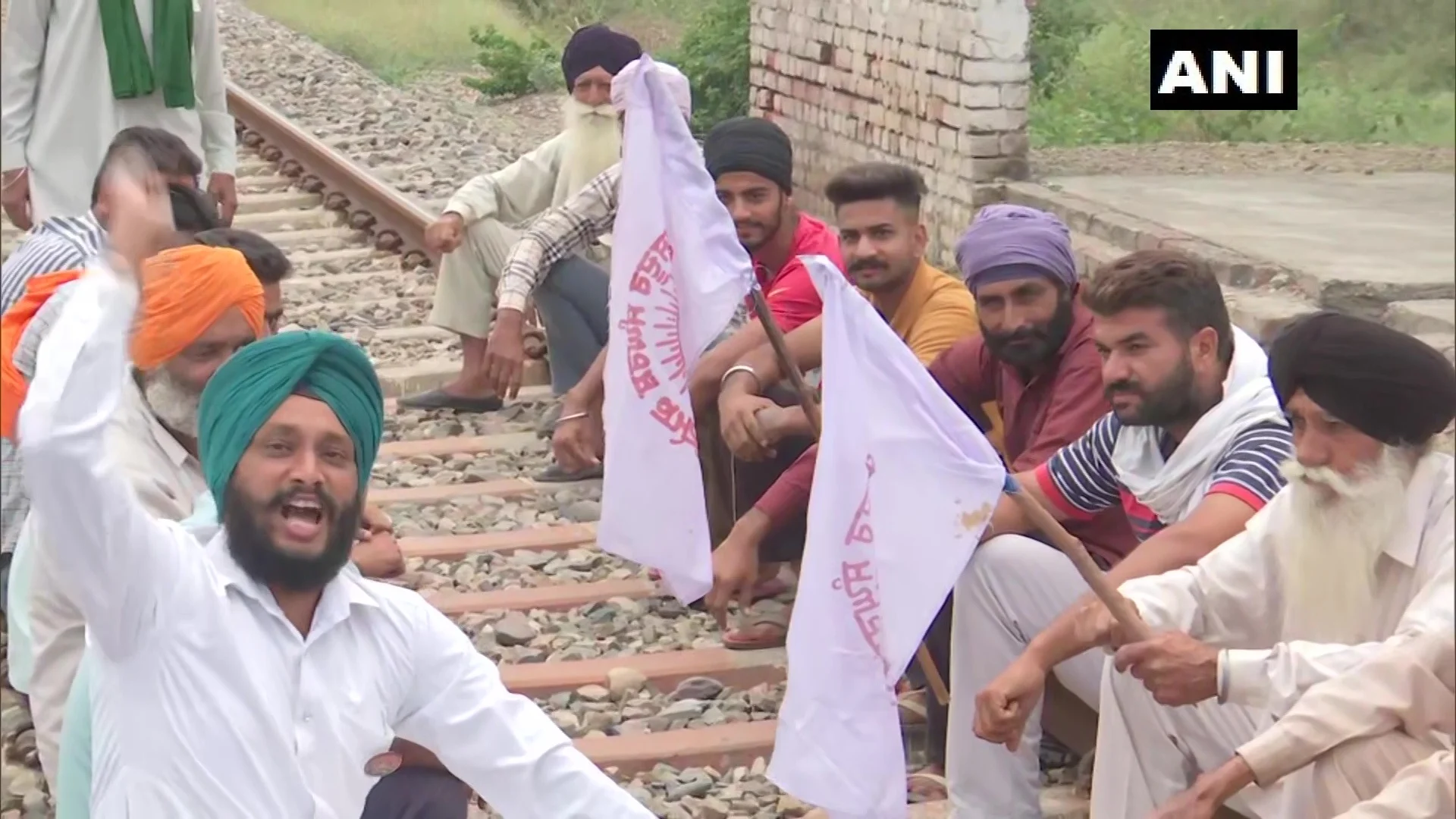 Farm law protestors sit on the railway track at Devi Dasspura village in Amritsar, Punjab, following the farmer's union call for 'Rail Roko Andolan' on Monday, October 18, 2021.