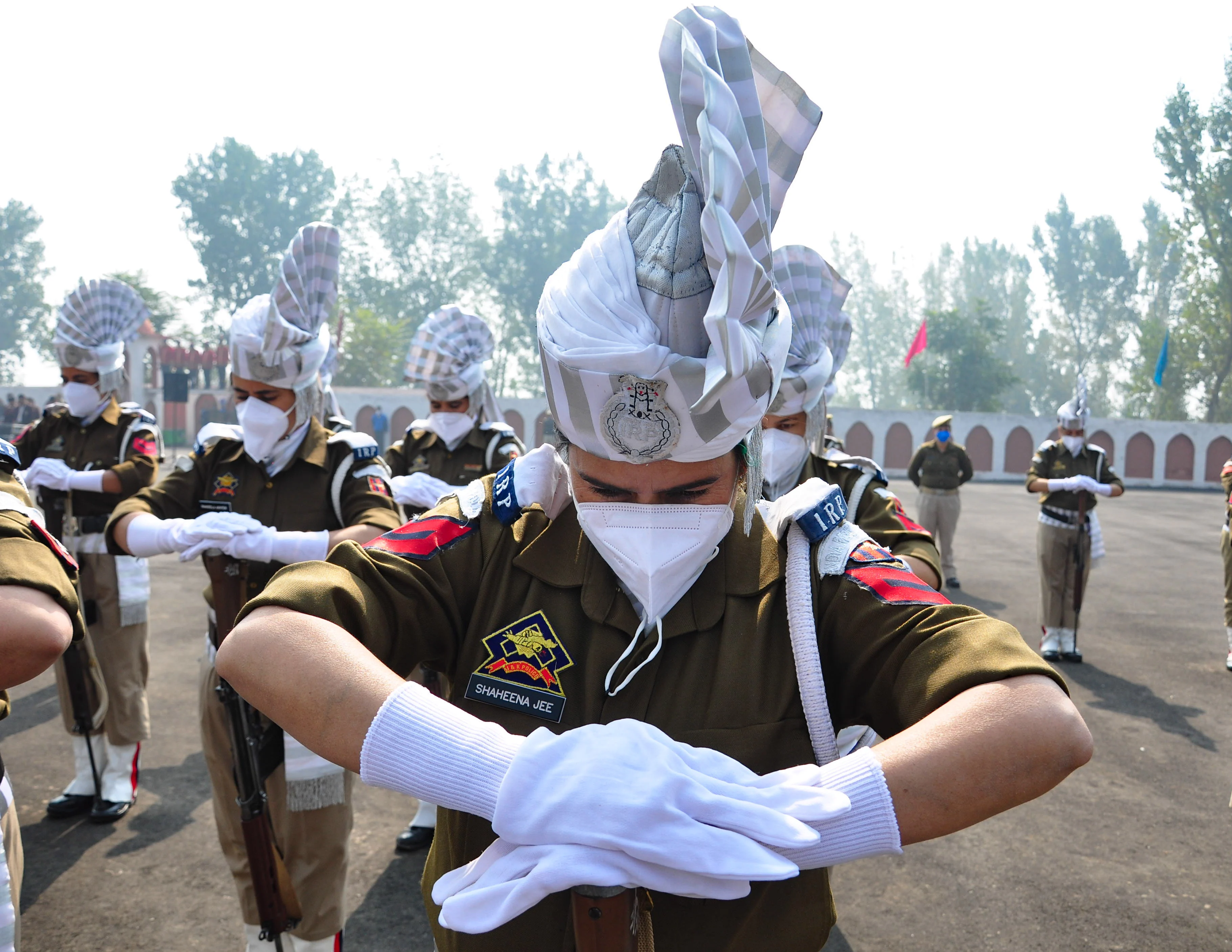 Policewomen bow their head in honor of the slain colleagues during a ceremony to mark the National Police Commemoration Day at the Police Training Centre in Zewan on the outskirts of Srinagar, on Thursday 21 October 2021.
